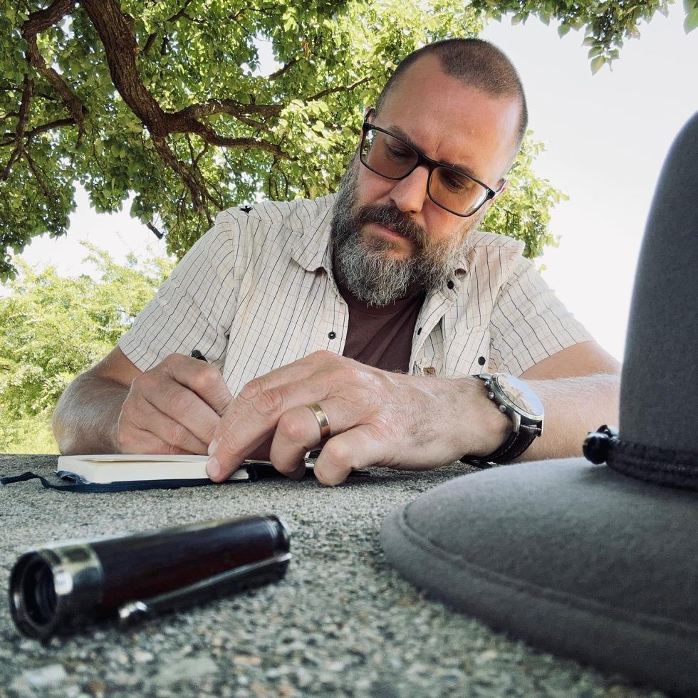 J. Ashley-Smith writing in a notebook